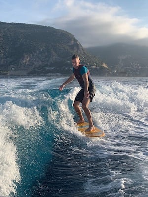 Photo of Mark from DSNM Ltd on a surfboard.