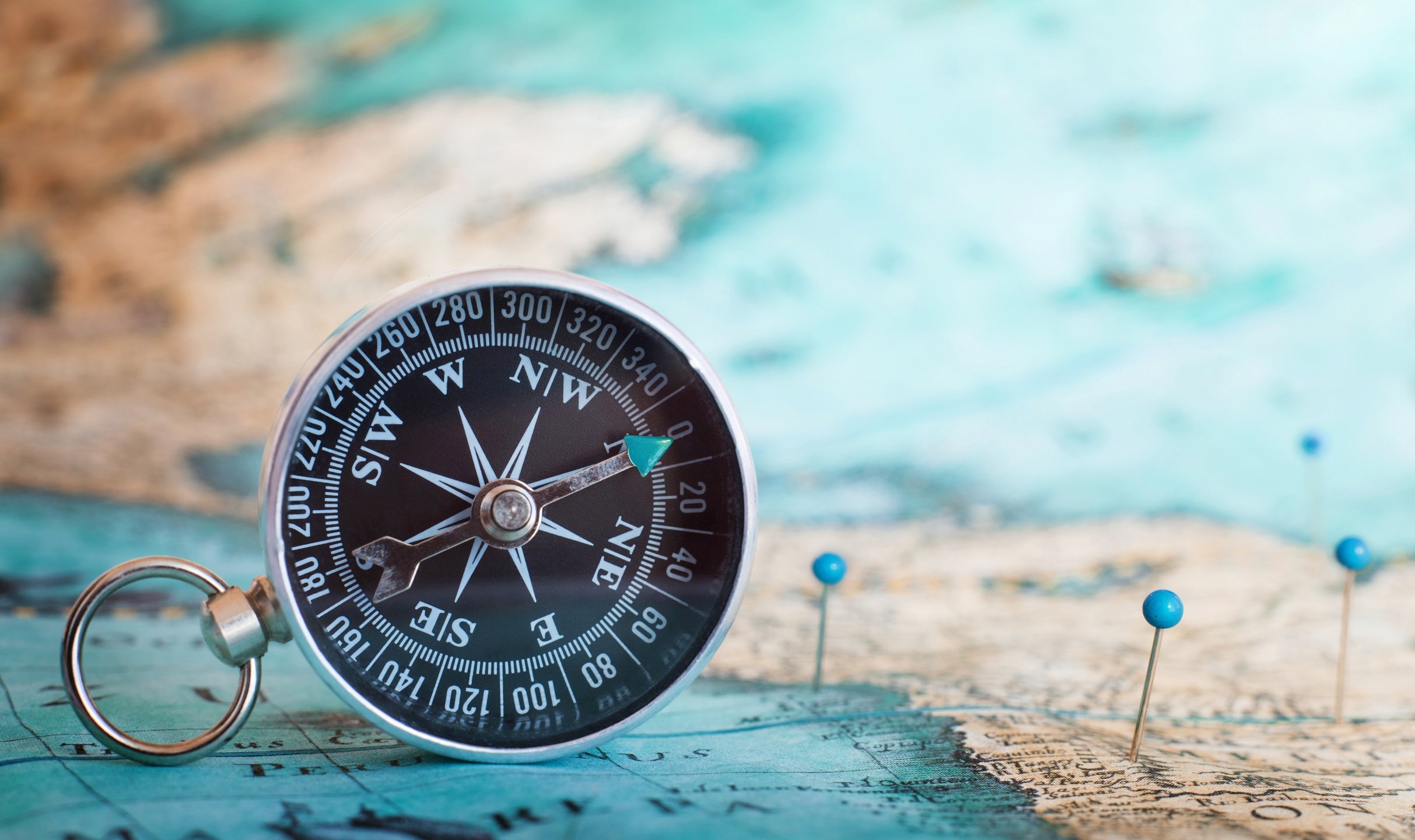 A compass on top of a map.