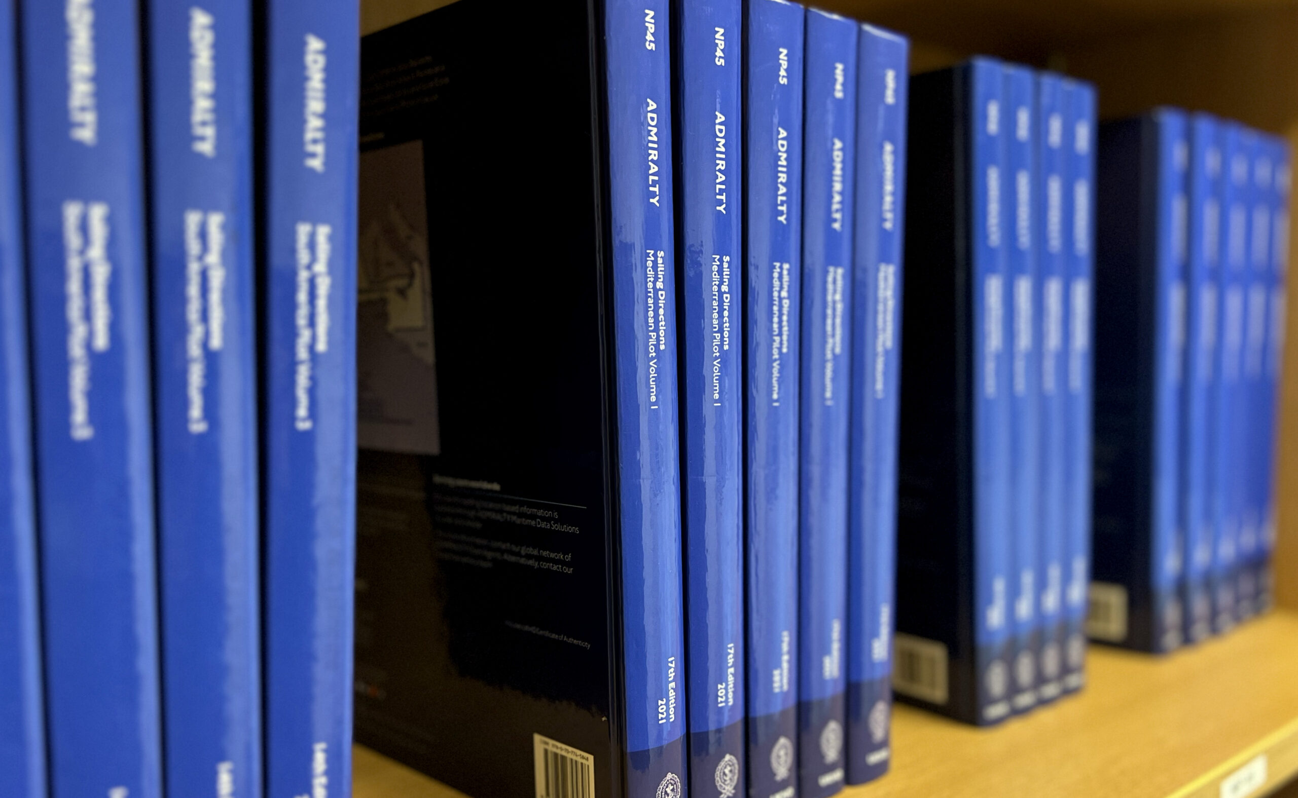 Blue admiralty books on a bookshelf