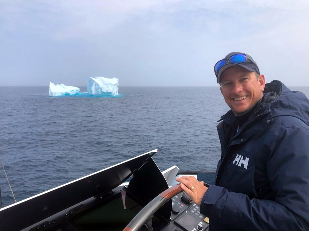 Stuart Laurie on boat next to iceberg