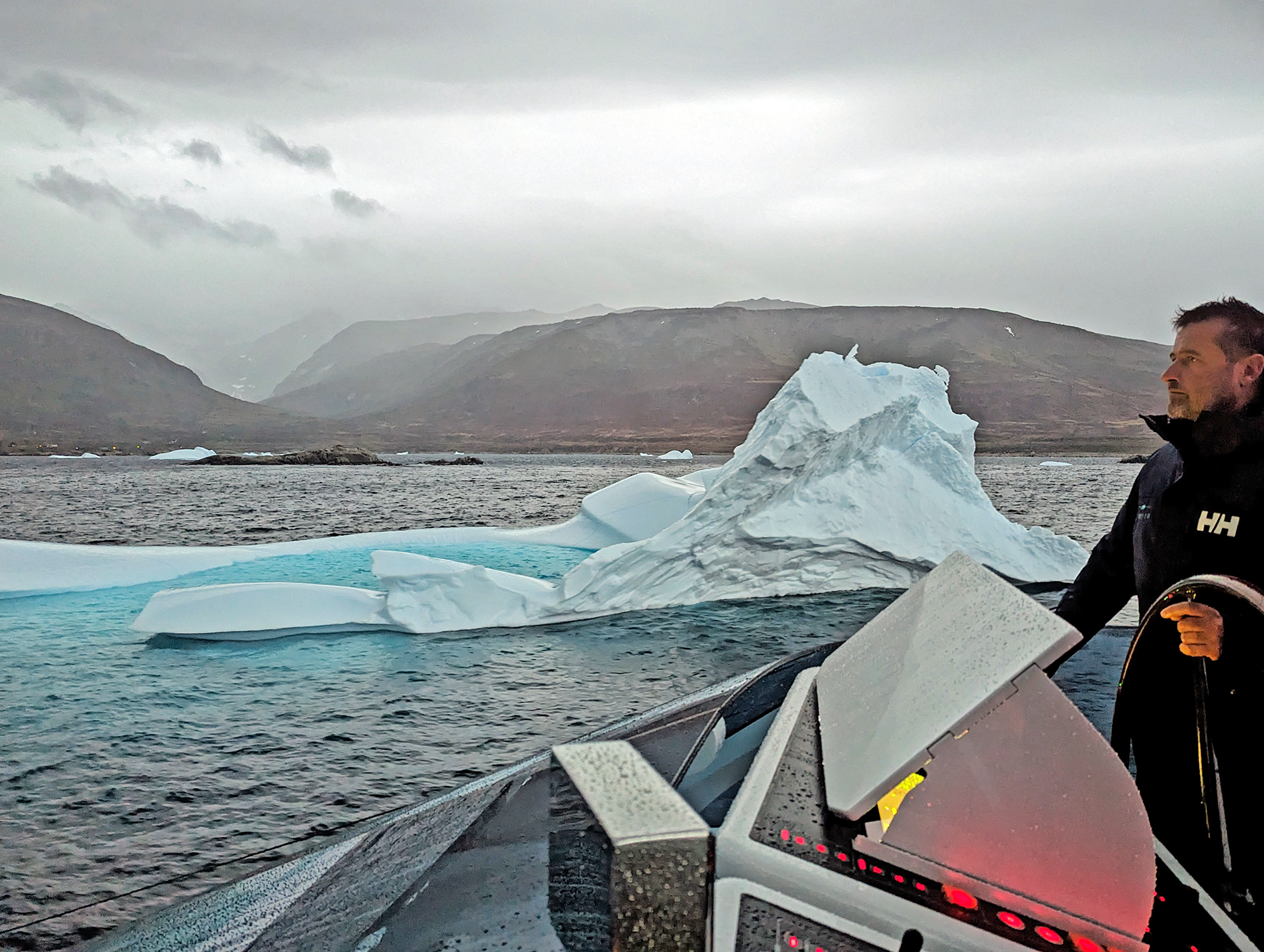 A person standing on a boat in the water.